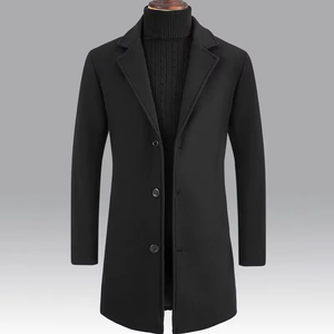 Black single-breasted wool-blend overcoat with notch lapels and three buttons, worn over a black turtleneck